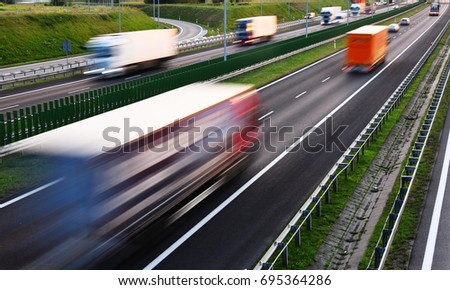 Trucks on four lane controlled-access highway in Poland.
 Royalty-Free Stock Photo #695364286