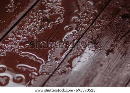 Rain drops on wooden table after rain. Empty wooden table with water drops.