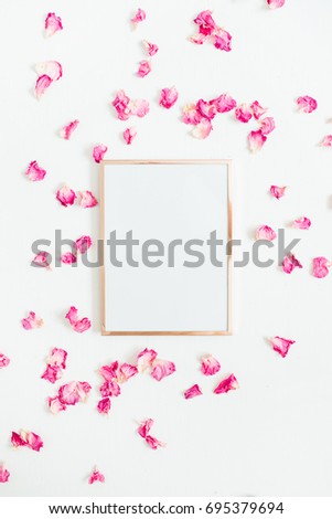 Photo frame mock up with space for text and pink rose petals on white background. Flat lay, top view. Valentine's minimal background.