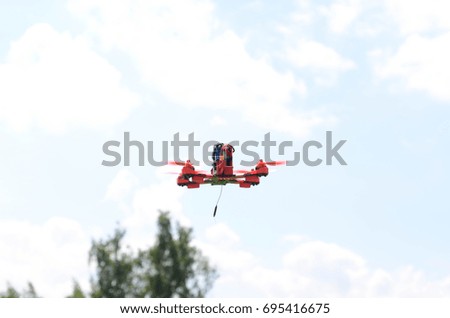 Quadracopter flying on sky background