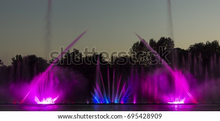 Musical fountain with colorful illuminations at night background