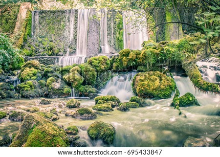 River waterfalls are located at the National Park Tara. Beautiful green moss all over the rocks shows the pure nature.  Royalty-Free Stock Photo #695433847