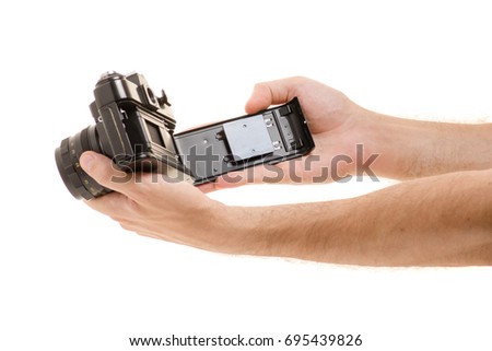 Old cameras in male hands on white background isolation