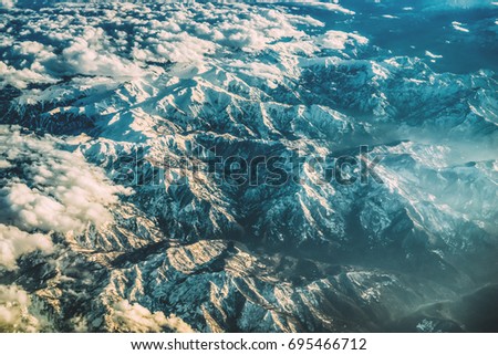 Epic sunset mountains in clouds landscape. High attitude shot. Copy space. Travel inspiration. 