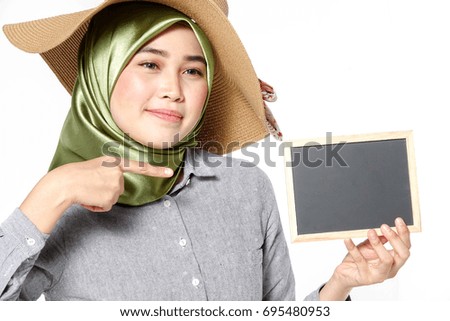 Veiled beautiful lady holds blackboard isolated on white.