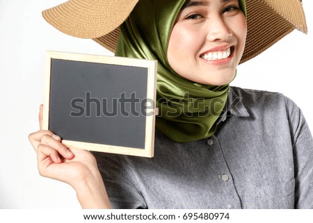 Veiled beautiful lady holds blackboard isolated on white.
