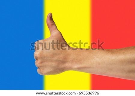 Thumbs up on a background of a flag of Romania