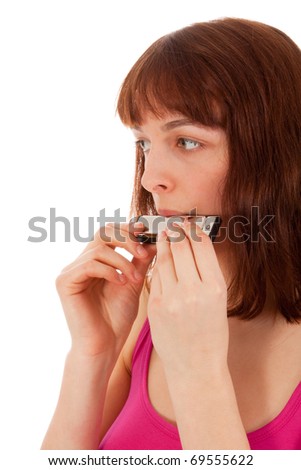 A beautiful young woman is playing harmonica