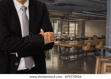 Male model in a suit posing on office background