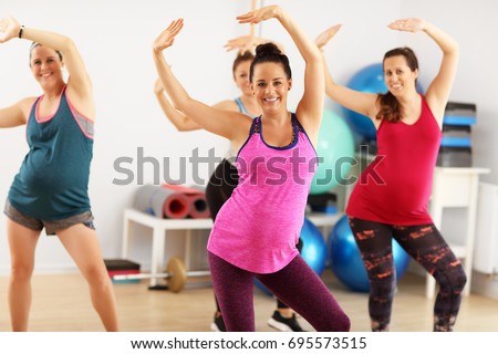 Group of pregnant women during fitness class Royalty-Free Stock Photo #695573515