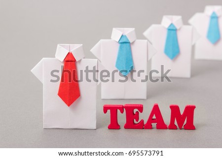 Office workers in a shirt and tie made of paper. Origami. Copy space for text.