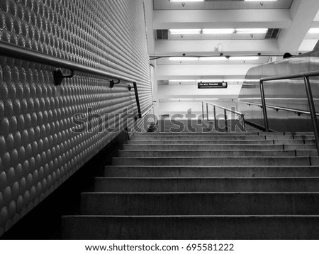 Black and white subway stairs ascending to exit