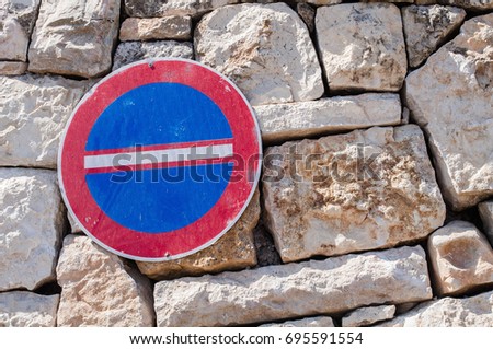 The sign "No enter" hangs on a stone old wall. Road sign. 
