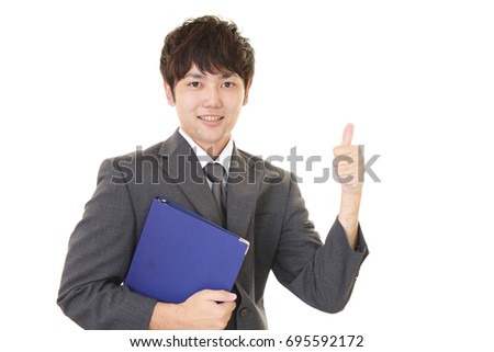 Asian business man showing thumbs up sign