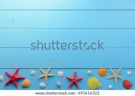 Summer sea background - shells, star on a wooden blue background