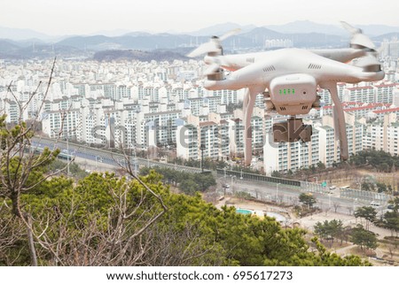 Drone with high resolution digital camera in flight over the city