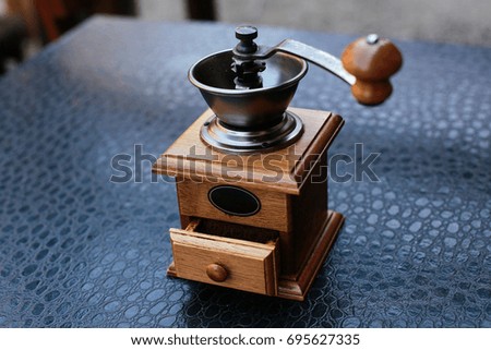 coffee beans are grinded in manual coffee grinder