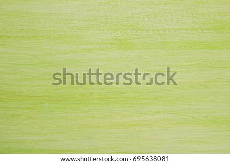 The bright painted green and white wooden textured background.