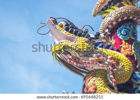 Dragon statues around the post and oil lamps. There is sky as background. Picture for background and add text. According to the belief of china.
