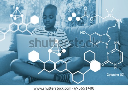 Digitally generated image of chemical structure against boy using laptop while listening to headphones at home