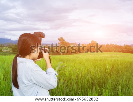 Girl holding camera,Look out to see nature.