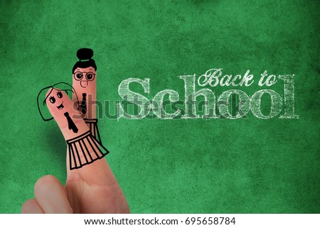 Anthropomorphic smiley faces of students on fingers against close-up of blackboard
