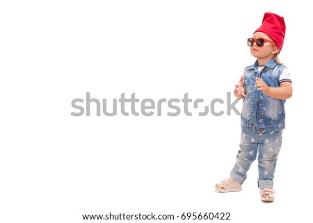 Adorable little girl in denim vest, red rimmed glasses and blue jeans. Studio shot. White background. Template for branding.     