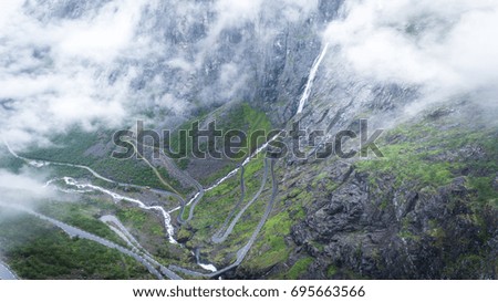 Famous Norwegian Trollstigen road going up the mountain through the clouds