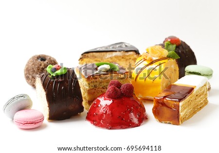 Assorted mini cakes sweet dessert, chocolate and fruit Royalty-Free Stock Photo #695694118