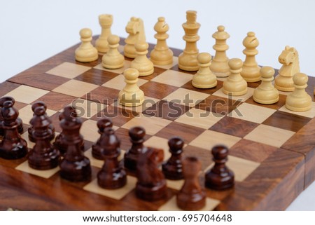 Chessboard with figures in progress isolated