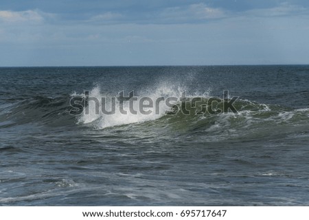 Sea surf on the beach with black volcanic sand in Kamchatka
