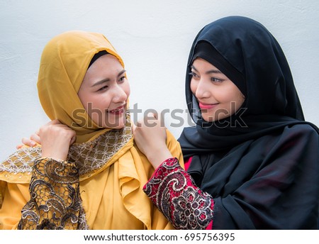 Portrait of two beautiful muslim woman having fun together isolated over white background, Portrait of close up two beautiful happy muslim woman,Age 20-30 years.