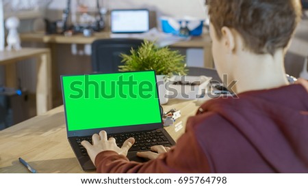 Smart Boy Uses Laptop with Mock-up Green Screen in His Computer Science Class.