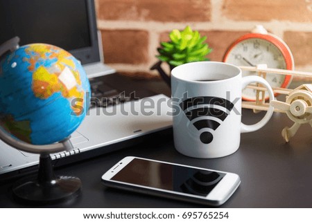 Table of office stuff Business man with Laptop, Wireless mouse, Smart phone, Toy wooden plane and Coffee Cup WIFI symbol.Concept office Business man workplace.