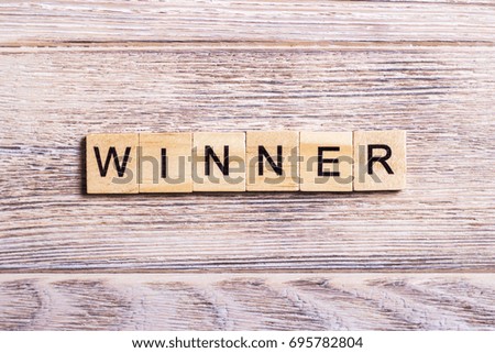word winner on cubes on wooden background