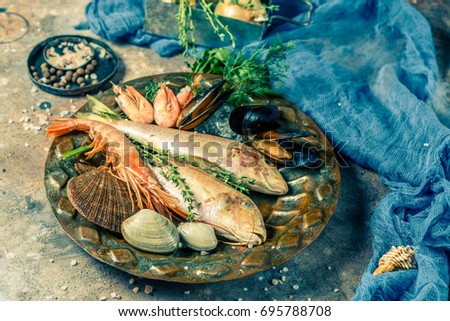 Photo of seafood on plate on stone table, photo above