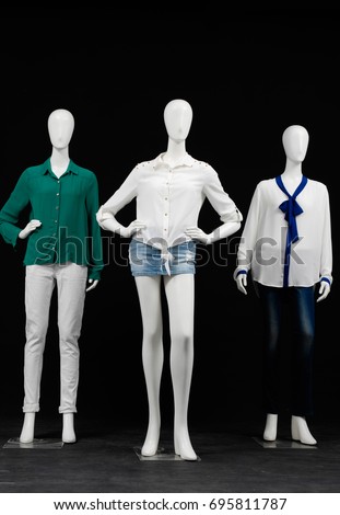 full-length mannequin in female shirt in white trousers, jeans isolated on black background

