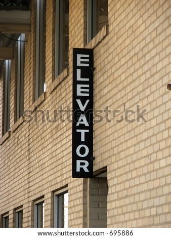 "ELEVATOR" sign on outside of building