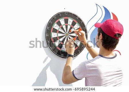 Young man playing darts