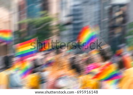 Motion blurred picture of gay rainbow flags during pride parade. Concept of LGBT rights.