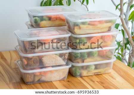 Meal prep. Stack of home cooked roast chicken dinners in containers ready to be frozen for later use.  Royalty-Free Stock Photo #695936533