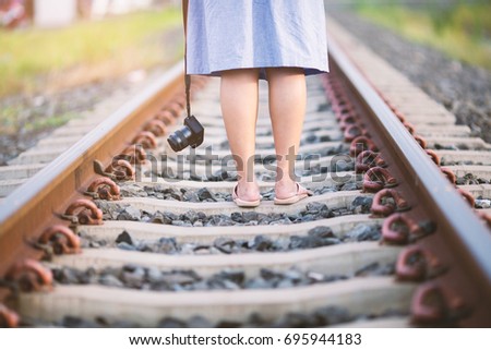  Young girl tourist photographed on railway