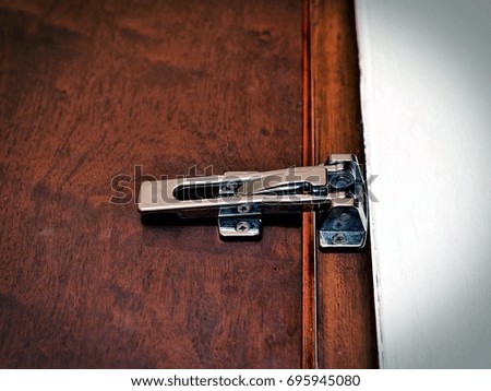 Modern stainless door lock on wooden door, image in vintage style.