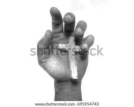 Close up dirty hand with Cross of Christ, monochrome isolated picture