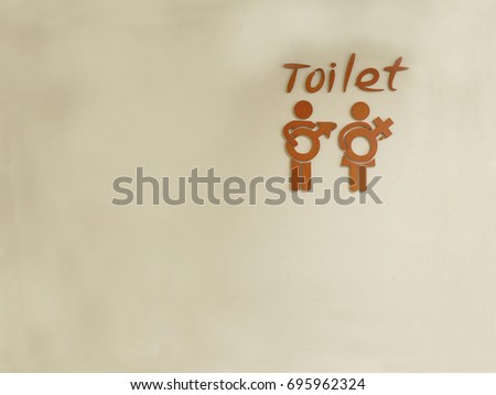 Male and female toilet sign on wall