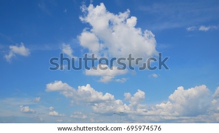 cumulus clouds against deep blue sky