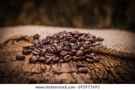 Coffee Beans on Sack textiles background area for copy space dark tone