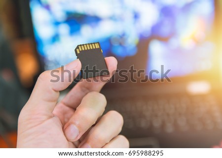Memory Card SD Digital Data storage with Computer blur background