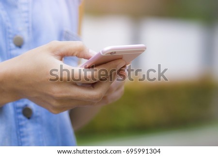 This image is a picture of a hands playing a smart phone.  The concept is technology,business,communication.