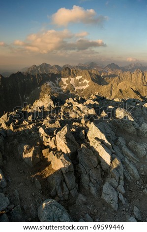 View of the high mountains with rocks on the foreground. Last rays of the sun in Slovakian Tatras.